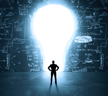 Bigger Idea Light bulb opening on a chalkboard